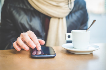 close up of woman hands with smartphone and cup of coffee