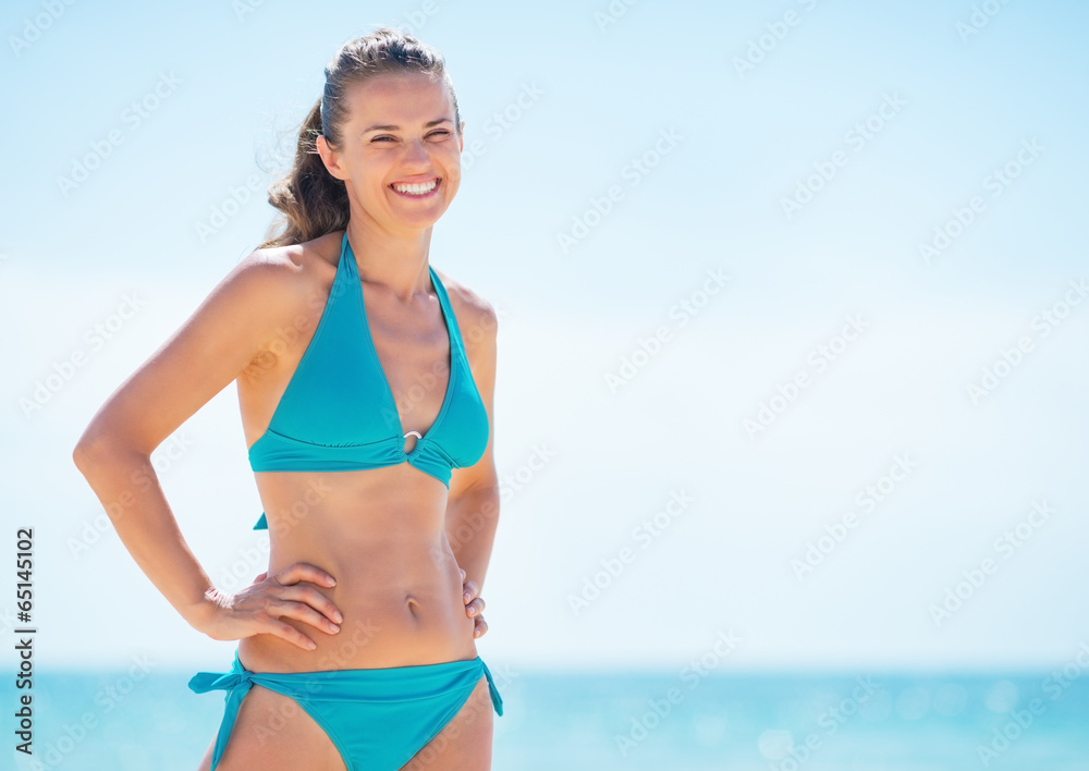 Wall mural portrait of happy young woman on beach