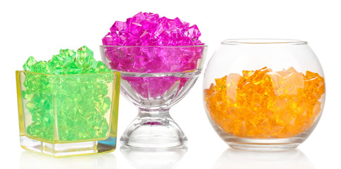 A glasses with colorful decorative stones isolated on white