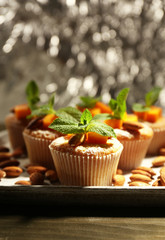 Tasty pumpkin muffins on wooden table