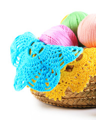 Colorful yarn balls for knitting in wicker basket, isolated
