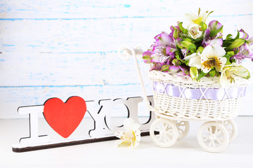 Bouquet of freesias on table on wooden background