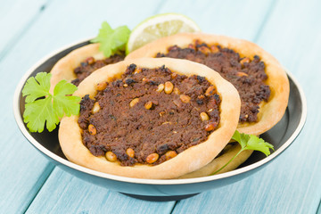 Lahm Bi Ajin - Flatbread topped with minced lamb and pine nuts