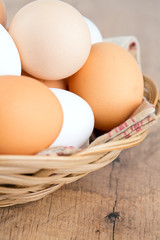 farm eggs in a basket on wooden table