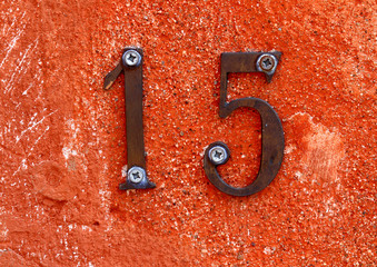 number fifteen formed from two digits one and five on the wall