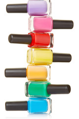Nail polish bottles colorful stack on white, clipping path