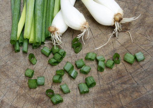 chopped green onions on wooden