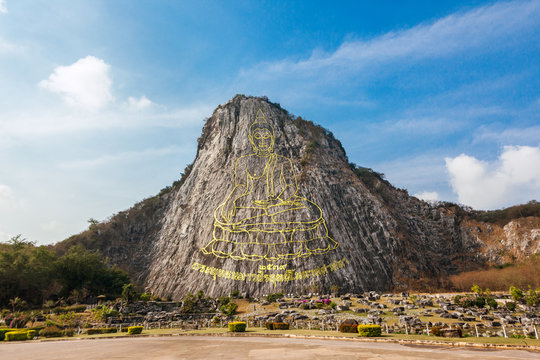 Carved golden buddha image on cliff at Khao Chee Jan, Thailand