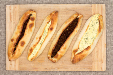 Four traditional Turkish pide with meat and cheese
