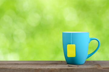 Cup of tea on green nature background