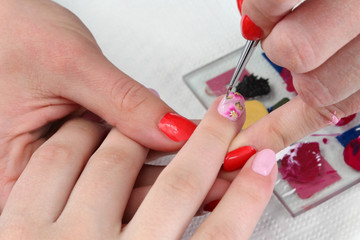 Finger nail treatment painting with brush and lacquer, makeup