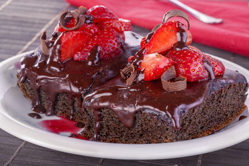 Delicious and sweet chocolate cake with fresh strawberries