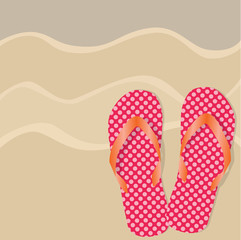 flip flops or sandals on a sandy beach background