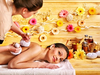 Obraz na płótnie Canvas Woman getting herbal ball massage.