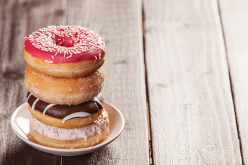 Donuts on woodent table.