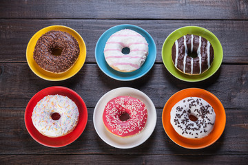 Donuts on wooden table.