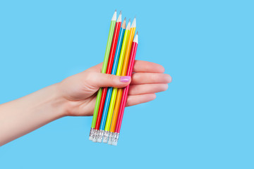Hand holding color pencils
