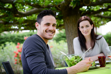 happy young loving couple lunch barbecue party outdoor garden