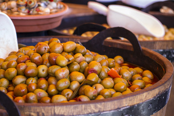 Wooden drums with olives and variants