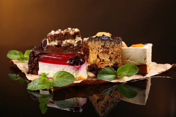 Assortment of pieces of cake, on dark background © Africa Studio