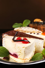 Assortment of pieces of cake, on dark background © Africa Studio