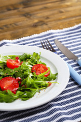 Green salad made with  arugula, tomatoes and sesame