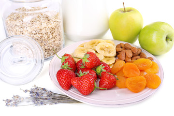 Healthy cereal with milk and fruits close up