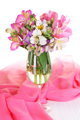 Freesias in glass on table close-up