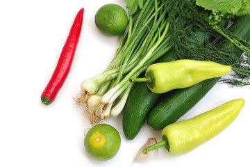 fresh green vegetables and chilli on white background