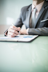 business report and man hand with pen