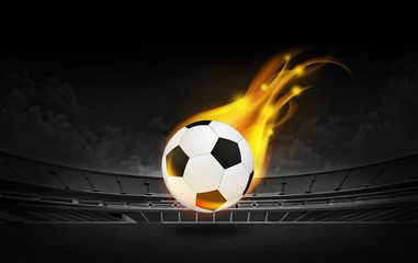 fiery soccer ball on playing field of stadium 