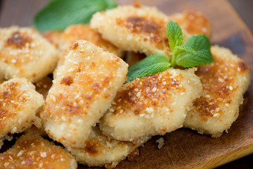 Sesame chicken nuggets with mint leaves, horizontal shot