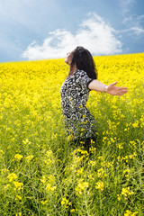 Fototapeta premium Happy woman in rapeseed field