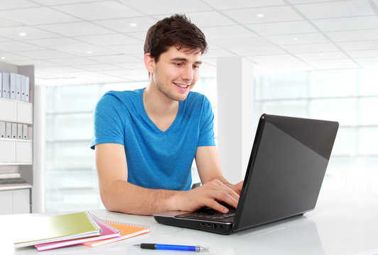 college student using his laptop