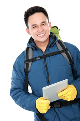 male hiker with backpack using tablet computer