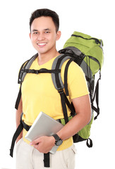 male hiker with backpack using tablet computer