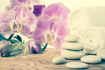 Fototapeta na wymiar fantastic Spa still life with stone, lilac orchid and towel, vin