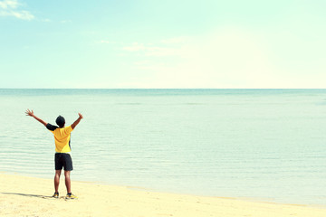 Fototapeta na wymiar man raised arm on the beach