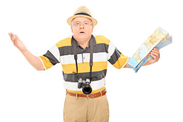 Confused mature tourist holding a map