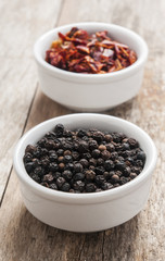 Black pepper on wood background