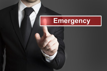 businessman in suite pressing touchscreen emergency
