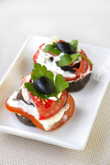 Aubergine appetizer with fresh tomato and cream cheese