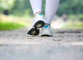 Woman walking in running shoes outdoors