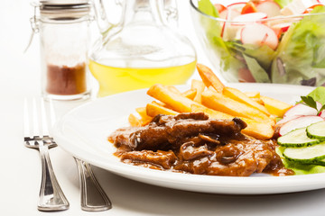Pork chop with sauce, mushrooms and chips
