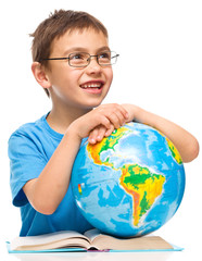 Little boy is holding globe