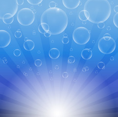 Soap bubbles on a blue background with lights