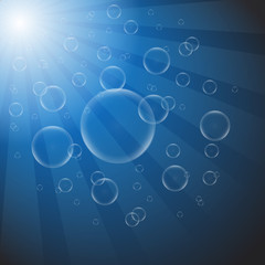 Soap bubbles on a blue background with lights