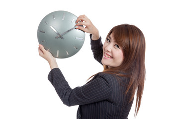 Asian Businesswoman move a clock hand and turn back