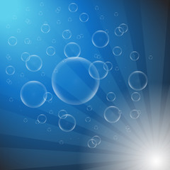 Soap bubbles on a blue background with lights