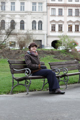 Obraz premium Woman sitting on a bench